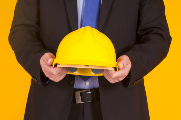 istock manager showing helmet on yellow background 1322270626