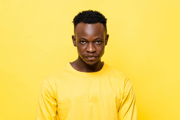 istock Young African man face on isolated yellow studio background 1322272533