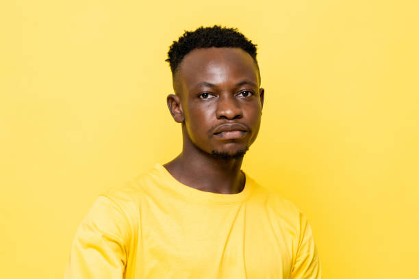 istock Young African man face on isolated yellow stuido background 1322272538