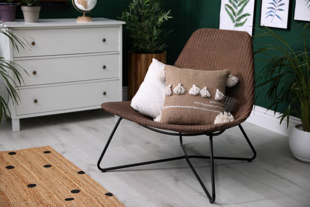 istock Comfortable wicker armchair with soft pillows in modern room. Interior design 1322274540