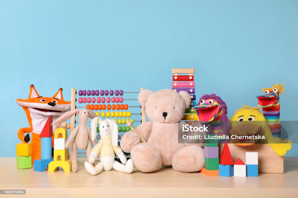 Collection of different toys on wooden table Toy Stock Photo