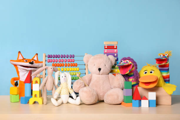 collection of different toys on wooden table - brinquedo imagens e fotografias de stock