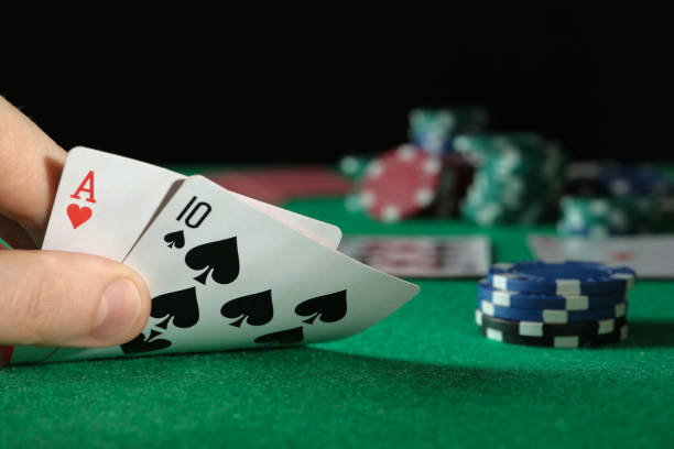 istock Man playing poker at table with casino chips, closeup. Space for text 1322276047