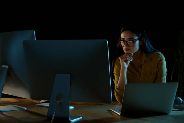 Programmer working in modern office at night Programmer working in modern office at night data breach photos stock pictures, royalty-free photos & images
