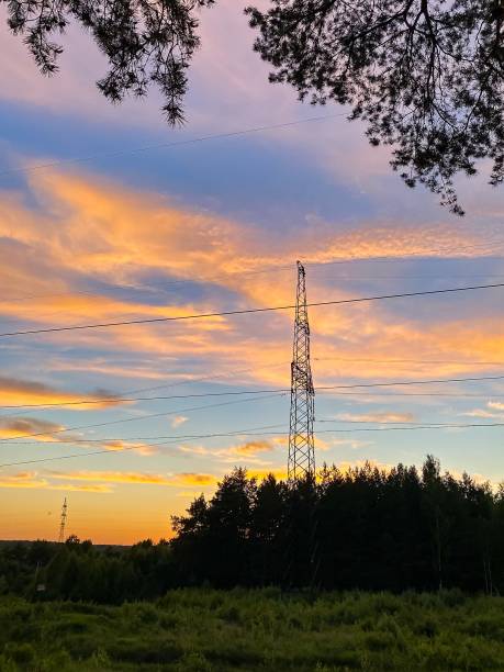 istock Perfect sunset over green field and electrical tower 1322276750