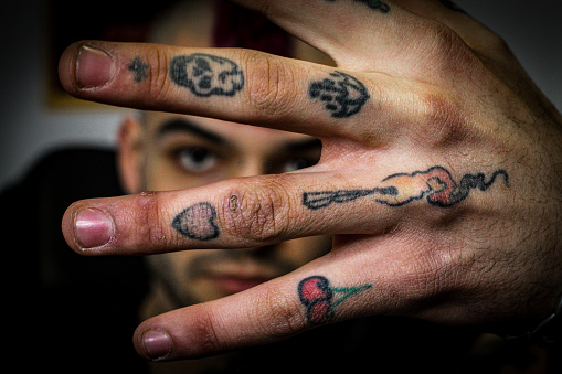 close-up creative portrait of a professional tattoo artist in his tattoo studio