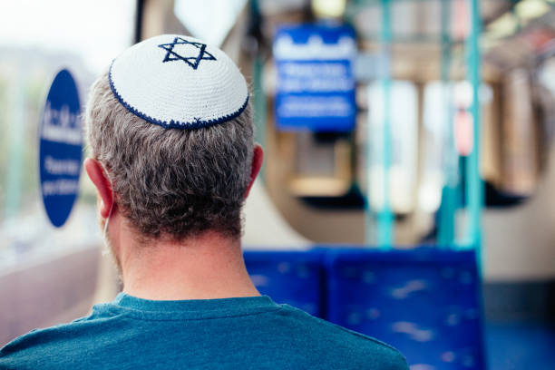 istock Jewish man wearing skull cap on passenger train 1322278135