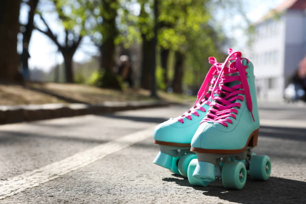 Stylish pink roller skates outdoors on sunny day. Space for text Stylish pink roller skates outdoors on sunny day. Space for text roller skating stock pictures, royalty-free photos & images