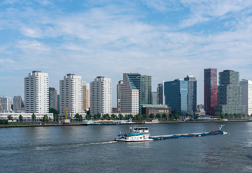 Panoramic view of the skyline of the city of Rotterdam with office and residential buildings along side the river Maas