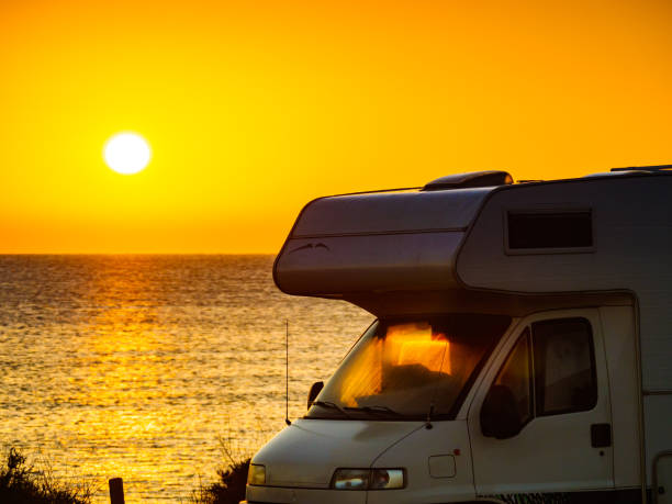 istock Camper vehicle on beach at sunrise 1322279130