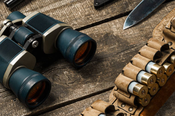 istock Hunting equipment binoculars on wooden background close up 1322280119
