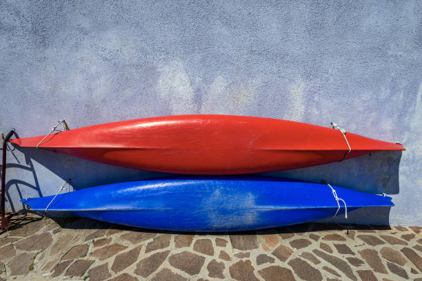 two canoes or kayaks hanging on the wall - burano island venice italy - kayaking kayak venice italy veneto imagens e fotografias de stock