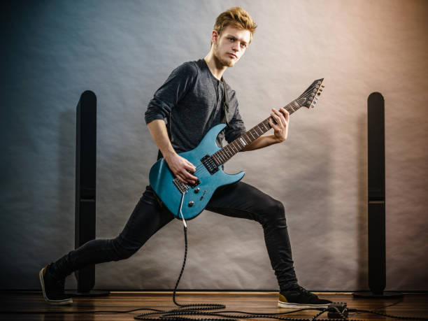 istock Young man playing electric guitar 1322280666