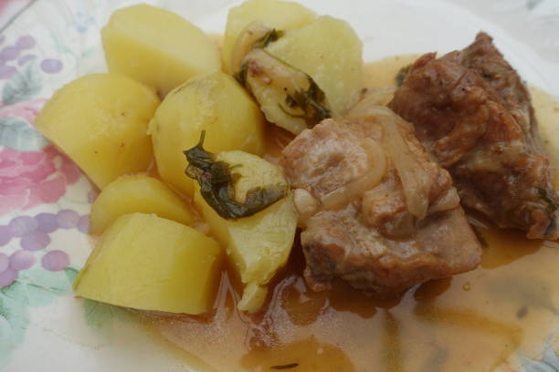 istock Veal stew cooked with white wine onions served with boiled potatoes 1322280918