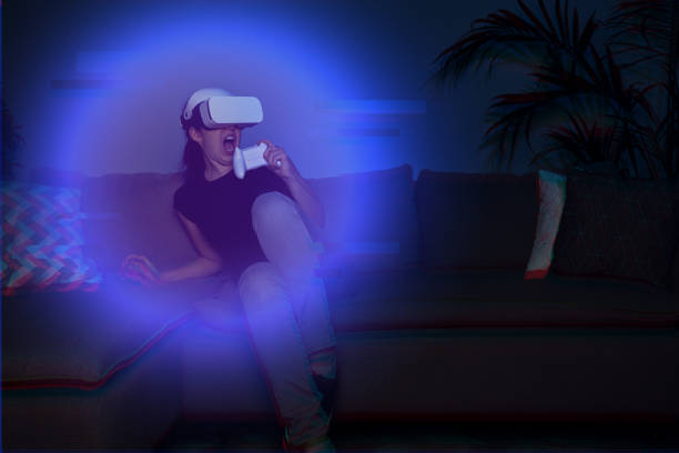 istock Woman playing game at home using vr headset 1322281474