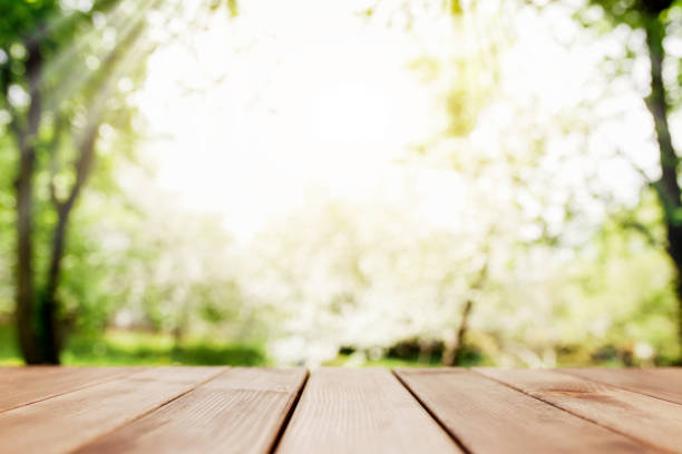 istock Sun rays on blurred view from wooden deck on balcony 1322282387
