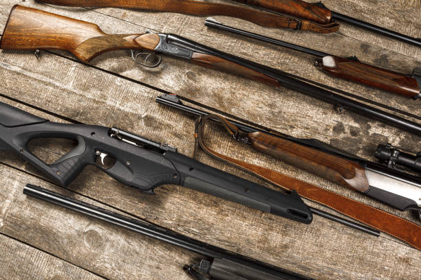 istock Many hunting rifles on weathered wooden surface 1322283822