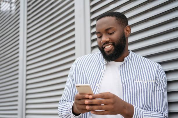 istock African man using mobile phone, shopping online 1322285297