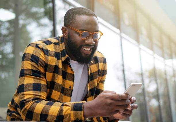 African man using mobile phone, shopping online