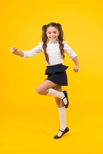 istock Keep going. Active kid. Girl on way knowledge. Knowledge day. Back to school. Kid cheerful schoolgirl running. Pupil want study. Active child in motion. Freedom concept. Knowledge determined success 1322286051