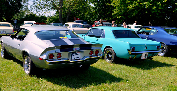 Iola, WI - July 07, 2022: High perspective front corner view of a 1967 Oldsmobile 442 Cutlass Supreme Holiday Coupe at a local car show.