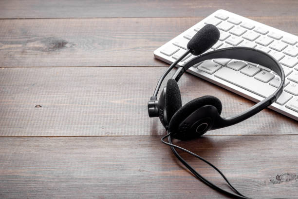 istock Communication support call center. Voip headset on offise desk 1322290773