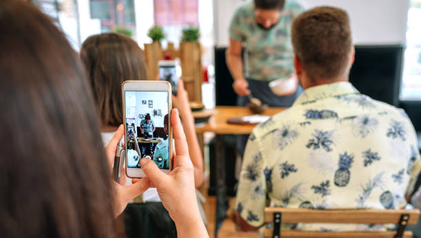 istock Woman taking photo with mobile in a cooking workshop 1322291370