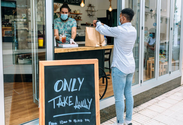 istock Man picking up take away food order 1322291375