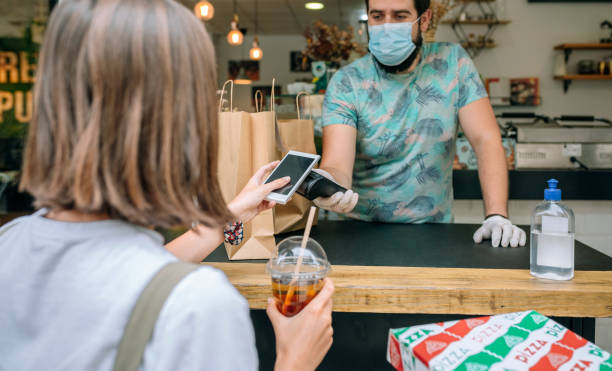 istock Woman paying with mobile a take away order 1322291380