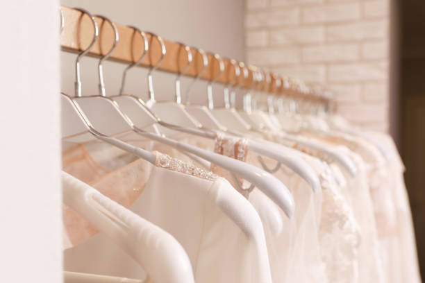 istock Different wedding dresses on hangers in boutique, closeup 1322292146