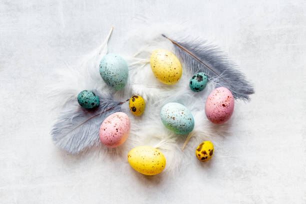 istock Happy Easter card with colorful eggs and feather. Overhead view 1322292541