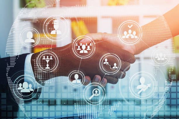 istock Two businesspeople shake hands after making a good deal. Office interior on background. Concept of negotiations and recruitment process 1322294255