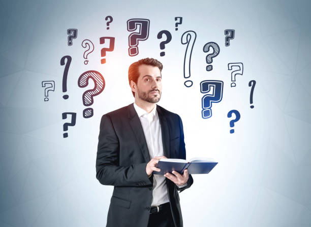 istock Businessman with notebook in hands, question marks sketch 1322294286