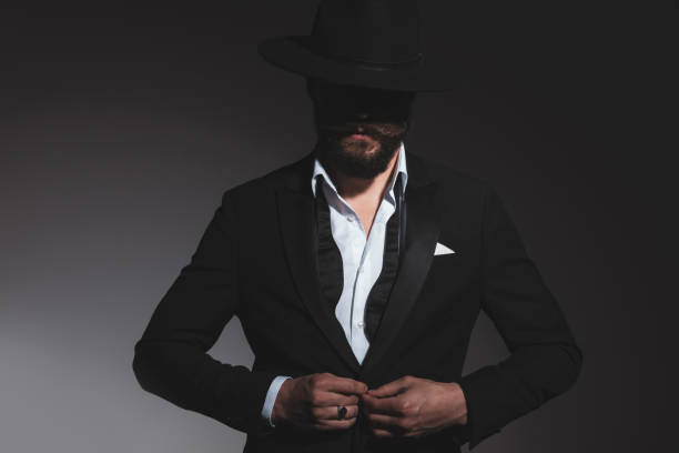 istock cool mysterious businessman arranging his tuxedo 1322295317