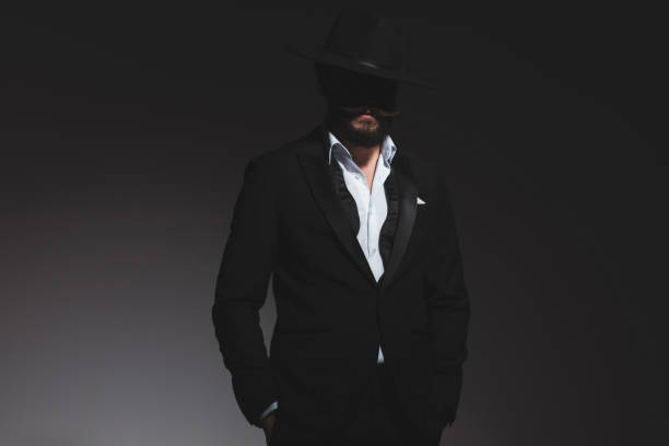 istock handsome mysterious businessman posing with his hands in pockets 1322295350