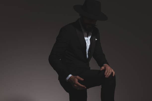 istock young mysterious businessman holding his leg 1322295372