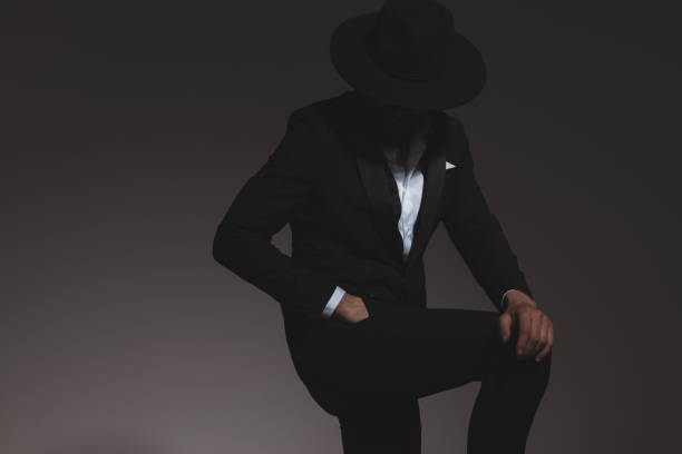 istock mysterious businessman hiding his eyes under his hat 1322295396