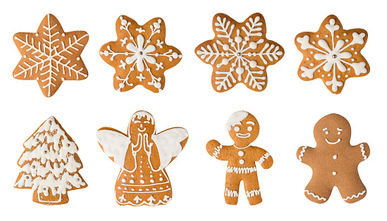 Christmas symbols. Smiling gingerbread men, angel, Christmas tree and snowflake cookies isolated on white background isolated on white background.
