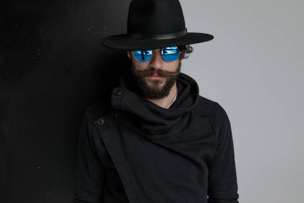 istock dramatic gypsy man with black hat and sunglasses posing 1322297072