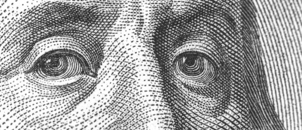istock Banner Benjamin Franklin's face on the US one hundred dollar bill, close-up 1322297136