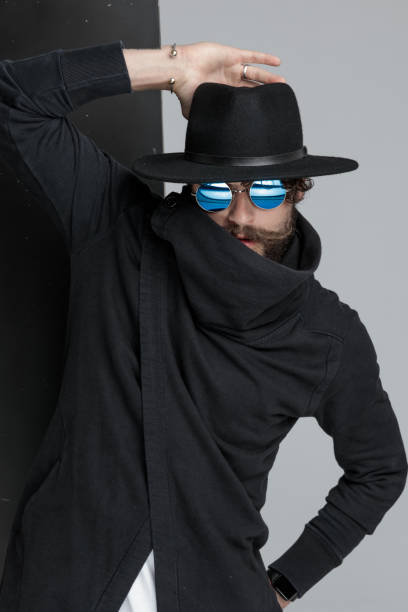 istock cool gypsy fashion model holding hand on hat and posing 1322297169