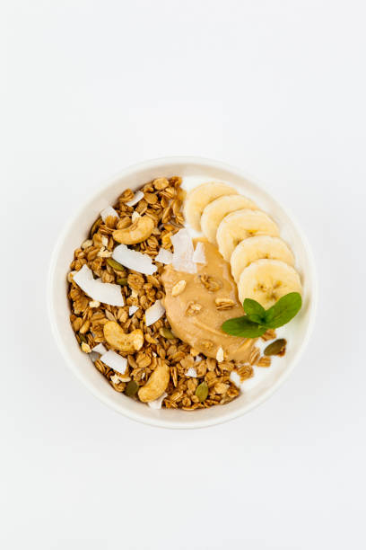 istock Bowl of granola with blueberries, peanut paste and yogurt on white top view. 1322297204