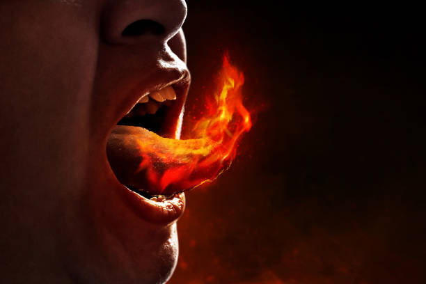 Young man eating spicy food