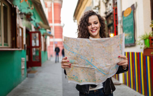 istock Cheerful woman searching direction on location map while traveling 1322299607