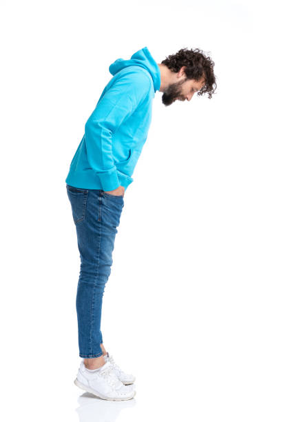 istock side view of handsome man holding hands in pockets and looking down 1322300209