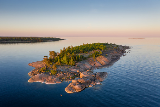 Summer evening in Finland. Beautiful rocky island at sunset aerial view.