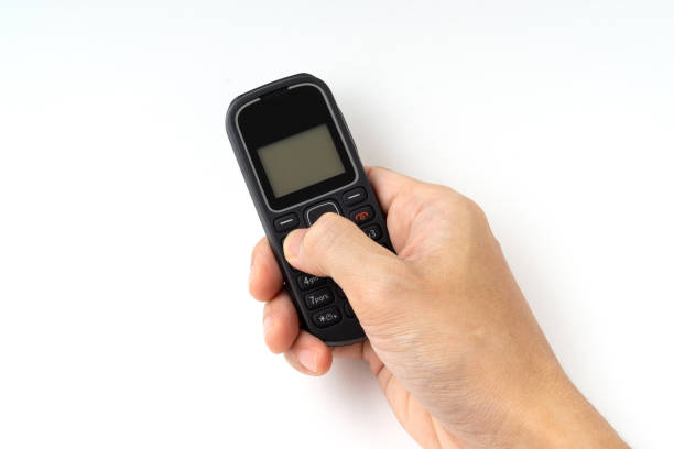 istock Hand a man holding of outdated mobile phone isolated on white background. 1322301281