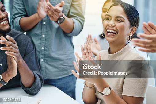 istock Shot of a group of business people applauding a team member 1322301721
