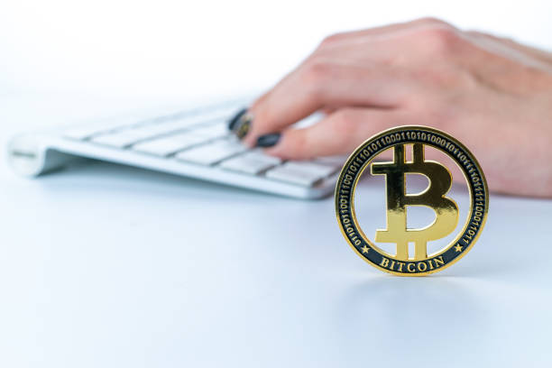 istock Bitcoin icon. Gold Crypto currency BTC Bitcoin with keyboard on white background. Golden Bit Coin virtual cryptocurrency or blockchain technology. Trading on the cryptocurrency exchange. 1322302740