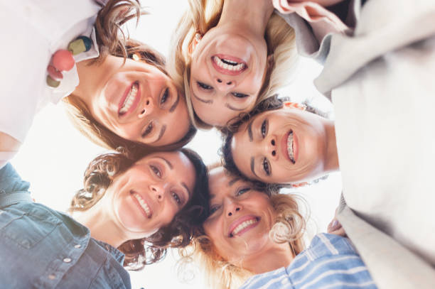 istock Circle of beautiful diverse young women looking at camera 1322304026